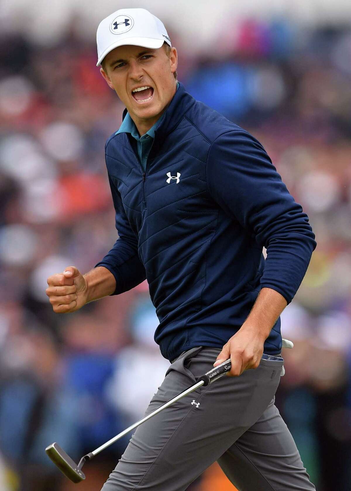 Jordan Spieth gets a charge out of making his 30-foot putt on the 16th green for birdie during the final round at Royal Birkdale.