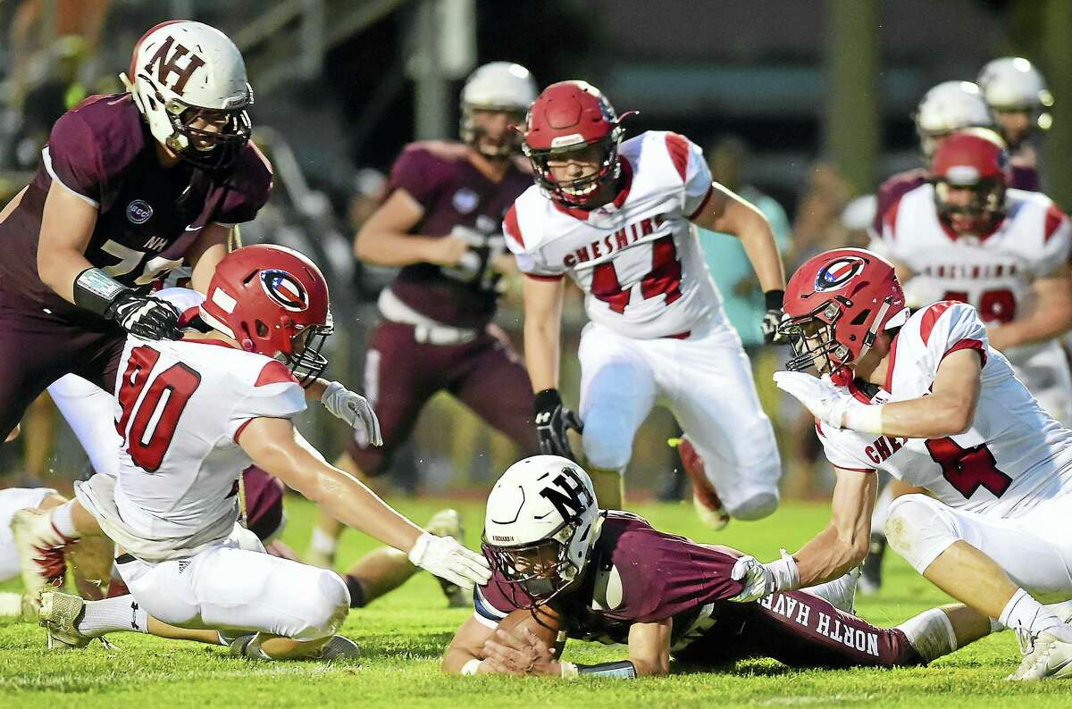 North Haven senior Tom Dodge recovers his fumble losing to Cheshire, 24-21, on opening night of high school football, Friday, September 9, 2016, at Mike Vanacore Field at the North Haven Athletic Complex. (Catherine Avalone/New Haven Register)