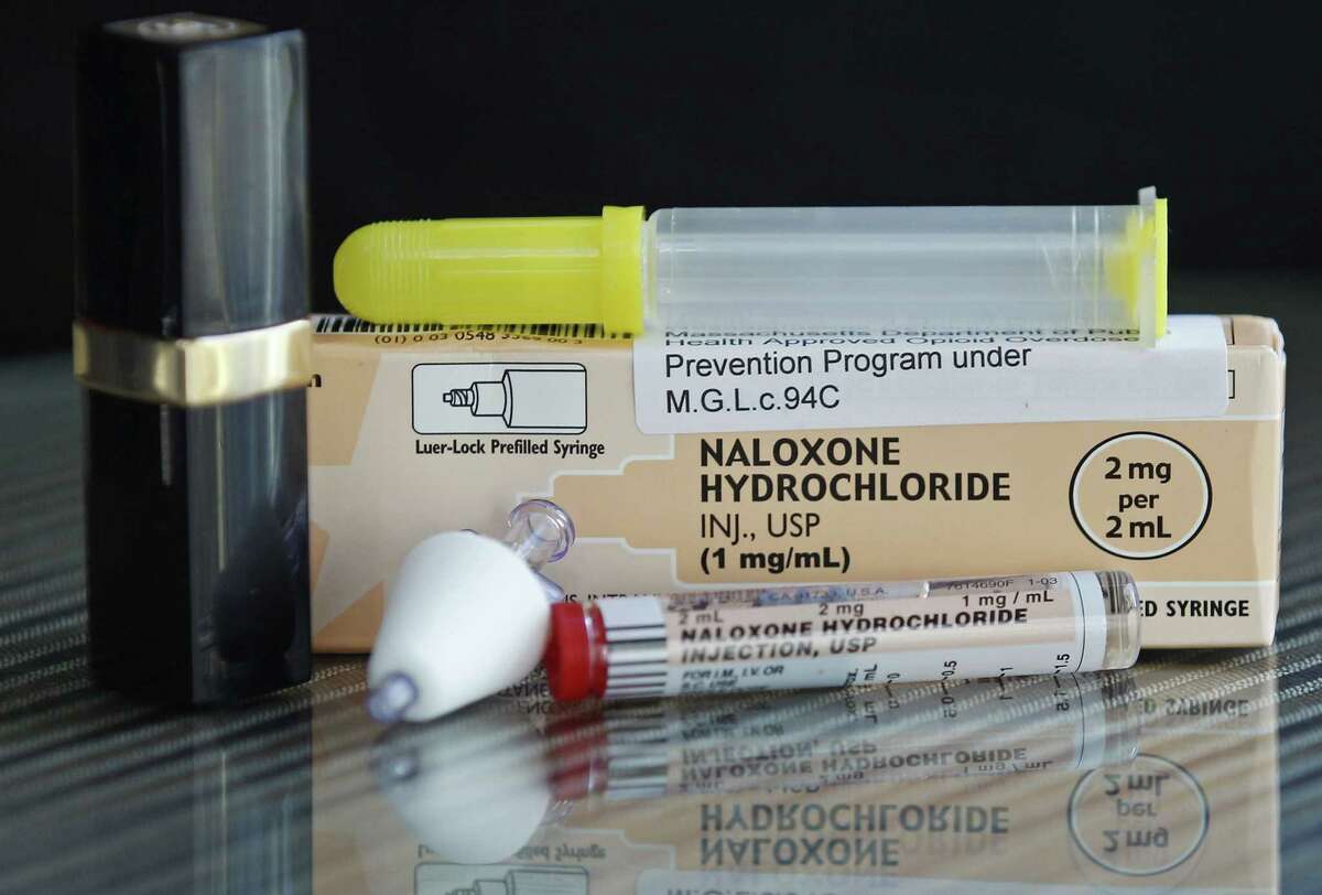 In this Tuesday, Feb. 27, 2012, photo, a tube of Naloxone Hydrochloride, also known as Narcan, is shown for scale next to a lipstick container in Quincy, Mass., home. Narcan is a nasal spray used as an antidote for opiate drug overdoses. The drug counteracts the effects of heroin, OxyContin and other powerful painkillers and has been routinely used by ambulance crews and emergency rooms in the U.S. and other countries for decades. But in the past few years, public health officials across the nation have been distributing it free to addicts and their loved ones, as well as to some police and firefighters.