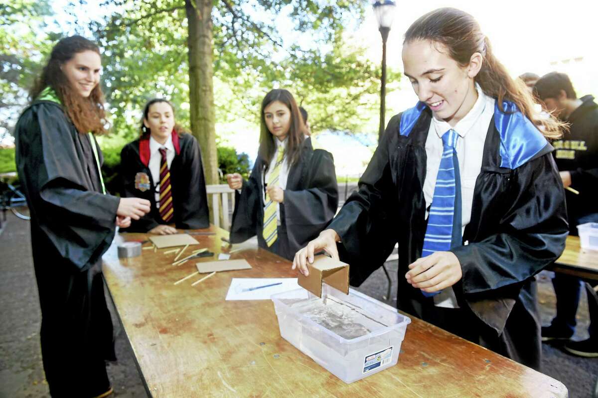 Arnold Gold — New Haven Register From left, Amelia Brown, Hannah Cabral, Jaclyn Levesque and Rebekah Pendrak of St. Mary Academy in Riverside, Rhode Island, construct a paddleboat outside of Yale University’s Sloan Physics Laboratory during the Yale Physics Olympics.