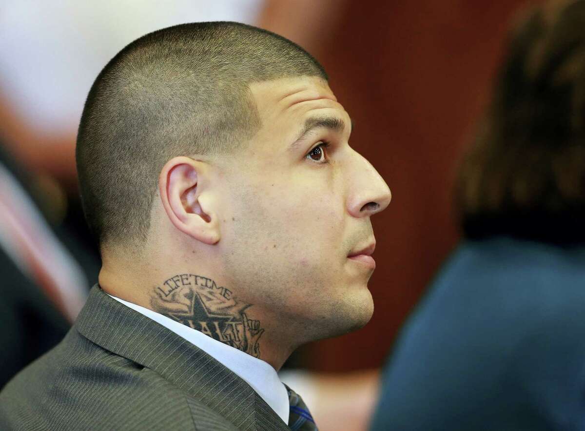 Aaron Hernandez, the former New England Patriots NFL football player, listens during a pre-trial hearing at Suffolk Superior Court on Tuesday in Boston. Judge Jeffrey Locke has set a trial date in February for Hernandez in a double murder case against him. Hernandez already is serving a life sentence for the 2013 killing of Odin Lloyd.