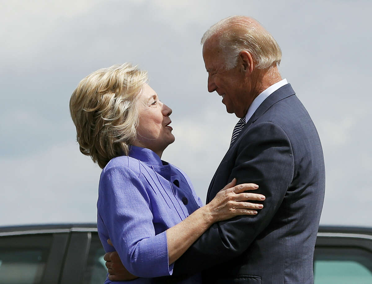 Democratic presidential candidate Hillary Clinton greets Vice President Joe Biden on the tarmac at Wilkes-Barre/Scranton International Airport in Avoca, Pa. on Aug. 15, 2016, before traveling together to a campaign event in Scranton, Pa.