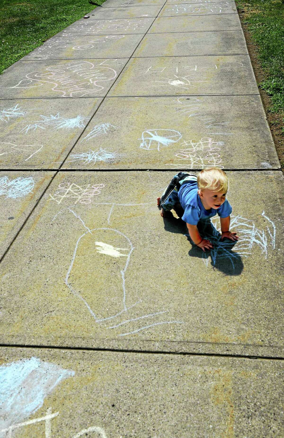 Tucker Blake, son of Milford Mayor Benjamin G. Blake, then 11 months, in front of Milford City Hall during Milford’s participation in Chalk the Walks 2015.