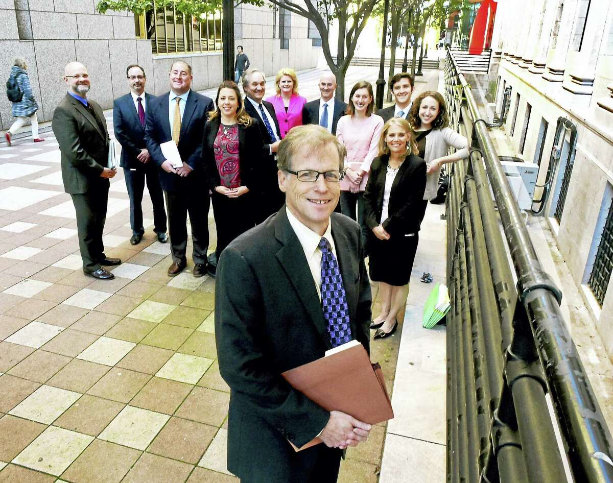 The Reentry Court is a new program that began this spring and is run by U.S. District Court Judge Jeffrey Meyer, bottom front in photo. The court aims to help those put away for violent crimes re-assimilate into society after 10 years or more in prison. The people in the photograph are a mix of U.S. probation officers, assistant U.S. attorneys, federal defense attorneys and court clerks involved in the program and include U.S. District Court Judge Jeffrey Meyer, Deborah Palmieri, Kim Gorton, Terence Ward, Robert Spector, Patrick Norton, Keith Barry, Warren Maxwell, Holly Wasilewski, Sarah Gruber, Danny Townsend, and Carly Levenson, outside the Federal Courthouse in New Haven.