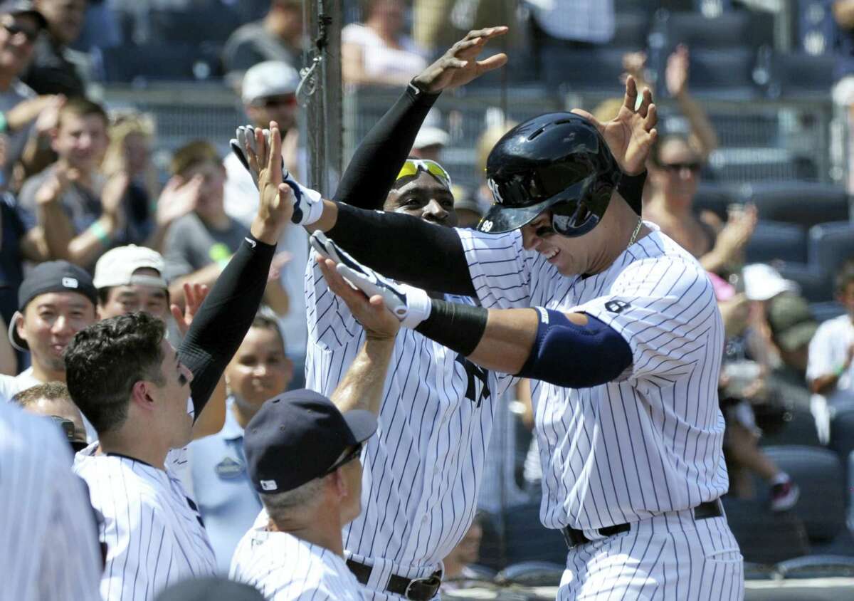 Aaron Judge, right, celebrates with teammates after hitting a home run during the second inning on Saturday.