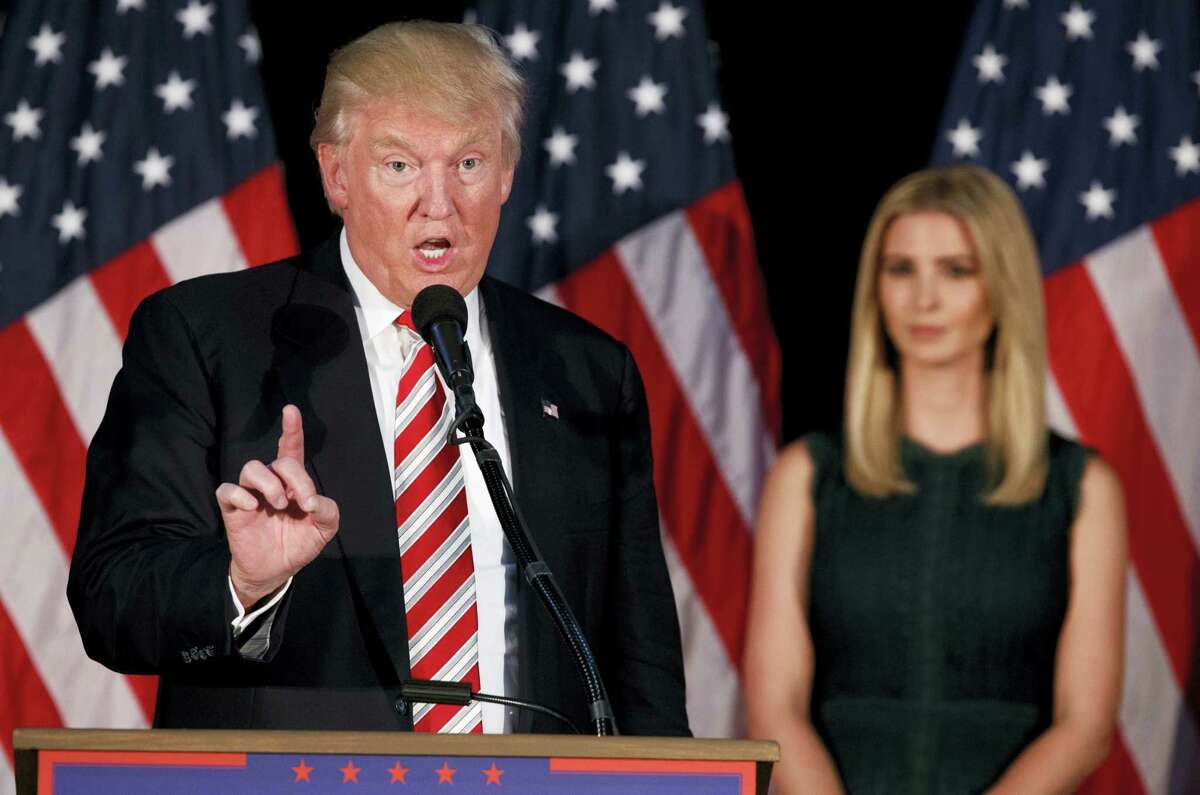 Ivanka Trump, right, watches as her father, Republican presidential candidate Donald Trump, delivers a policy speech on child care Tuesday in Aston, Penn.