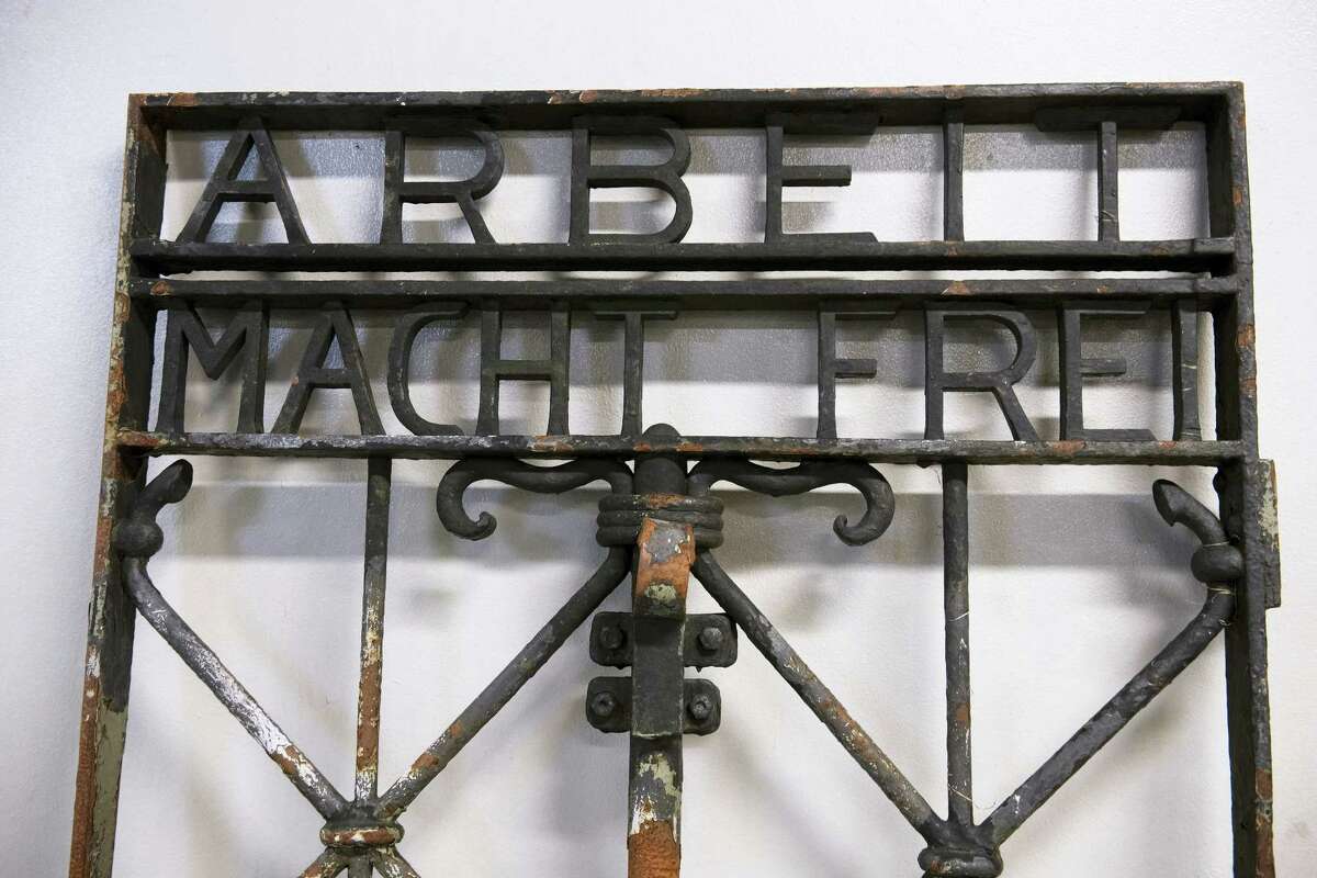 The iron gate from the former Nazi concentration camp in Dachau, southern Germany, with the slogan “Arbeit macht frei” (“Work will set you free”) is displayed Saturday Dec. 3, 2016, after being found earlier this week by police in Bergen, Norway. The infamous wrought iron gate was stolen two years ago, and is being cared for by police in Bergen before being returned to Germany.