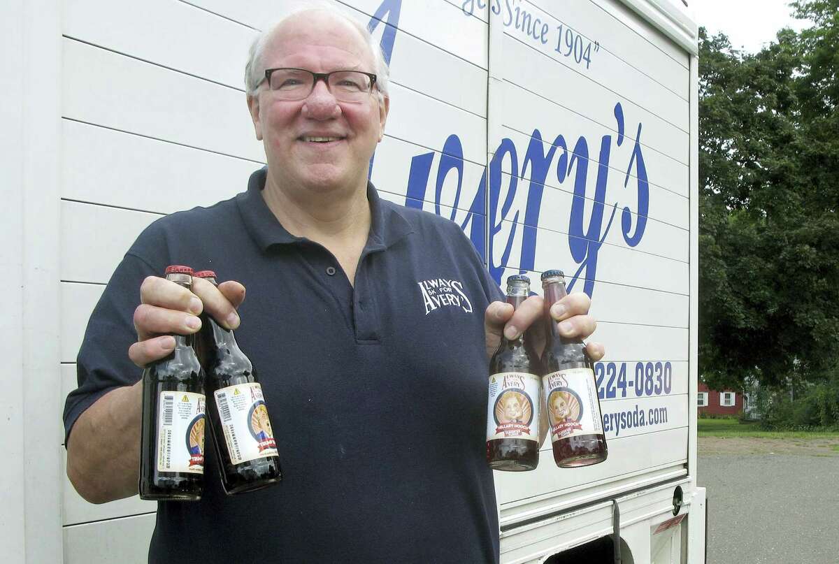 Rob Metz, general manager of Avery’s Beverages, holds samples of the company’s latest specialty sodas, Hillary Hooch and Trump Tonic, outside the Avery’s bottling facility Monday in New Britain. This is the third presidential race for which the company created candidate-based sodas and held a straw poll based on sales. During the last two cycles, Barack O’Berry beat John McCream and Cream de Mitt.