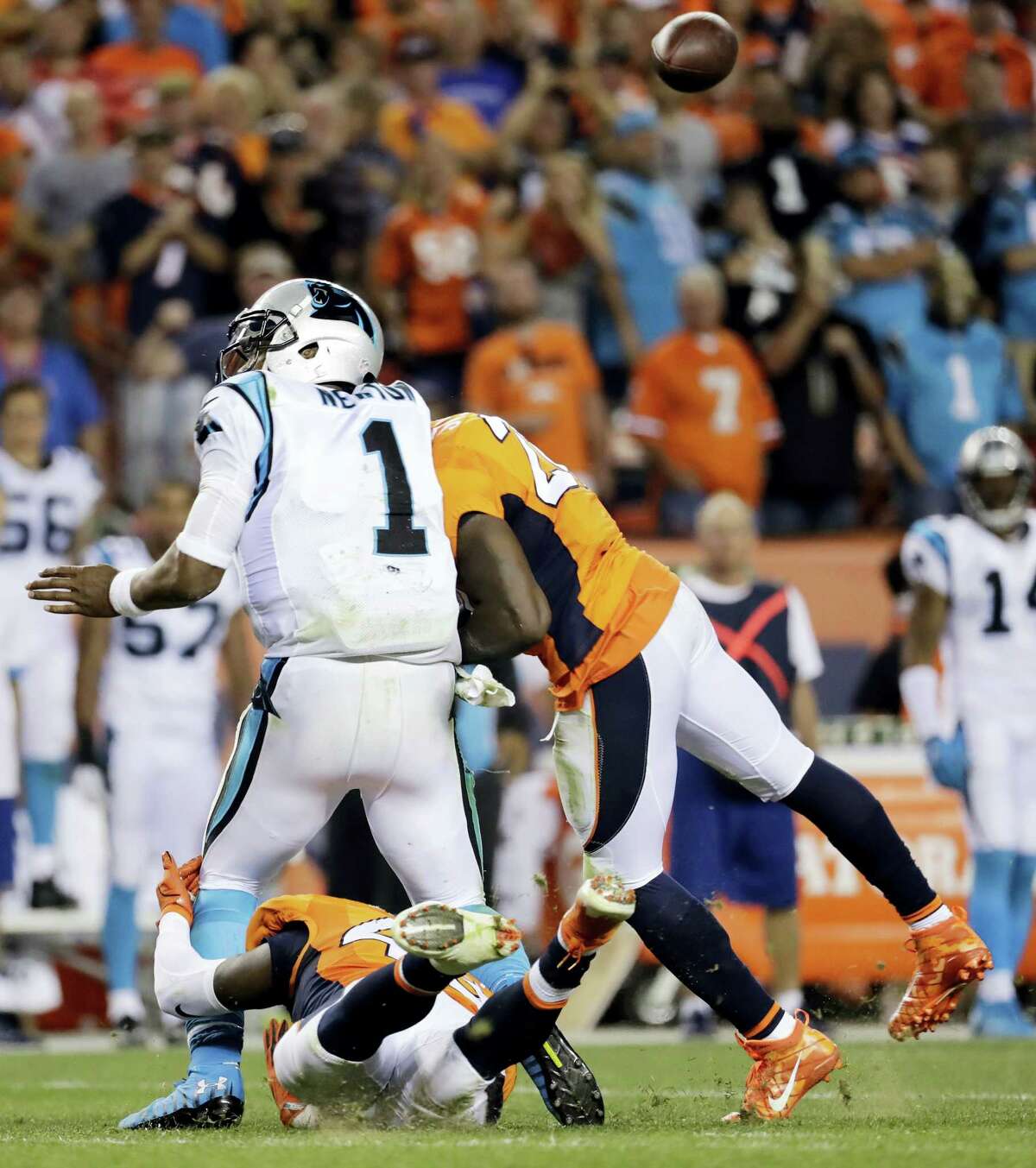 In this Sept. 8, 2016 photo, Denver Broncos free safety Darian Stewart (26) hits Carolina Panthers quarterback Cam Newton (1) late for a penalty during the second half of an NFL football game in Denver.