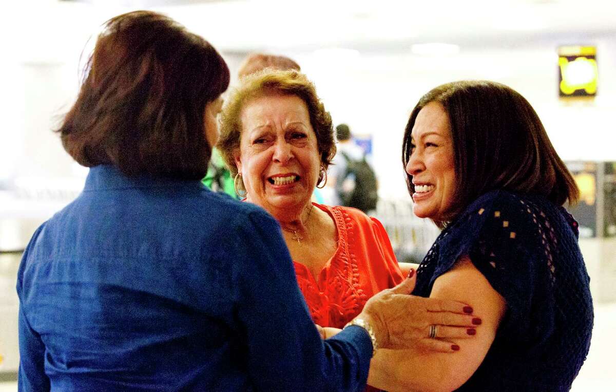 Jannett Balbas Eguchi, center, embraces Rachel Meforana as Emily Balbas Lonsberry Cook looks on as the three sisters meet for the first time at Bush Intercontinental Airport, Thursday, July 20, 2017, in Houston. Meforana, of Spring, was adopted when she was six months old in Manhattan and finally connected to long lost siblings from California she never knew about through ancestry.com this year.
