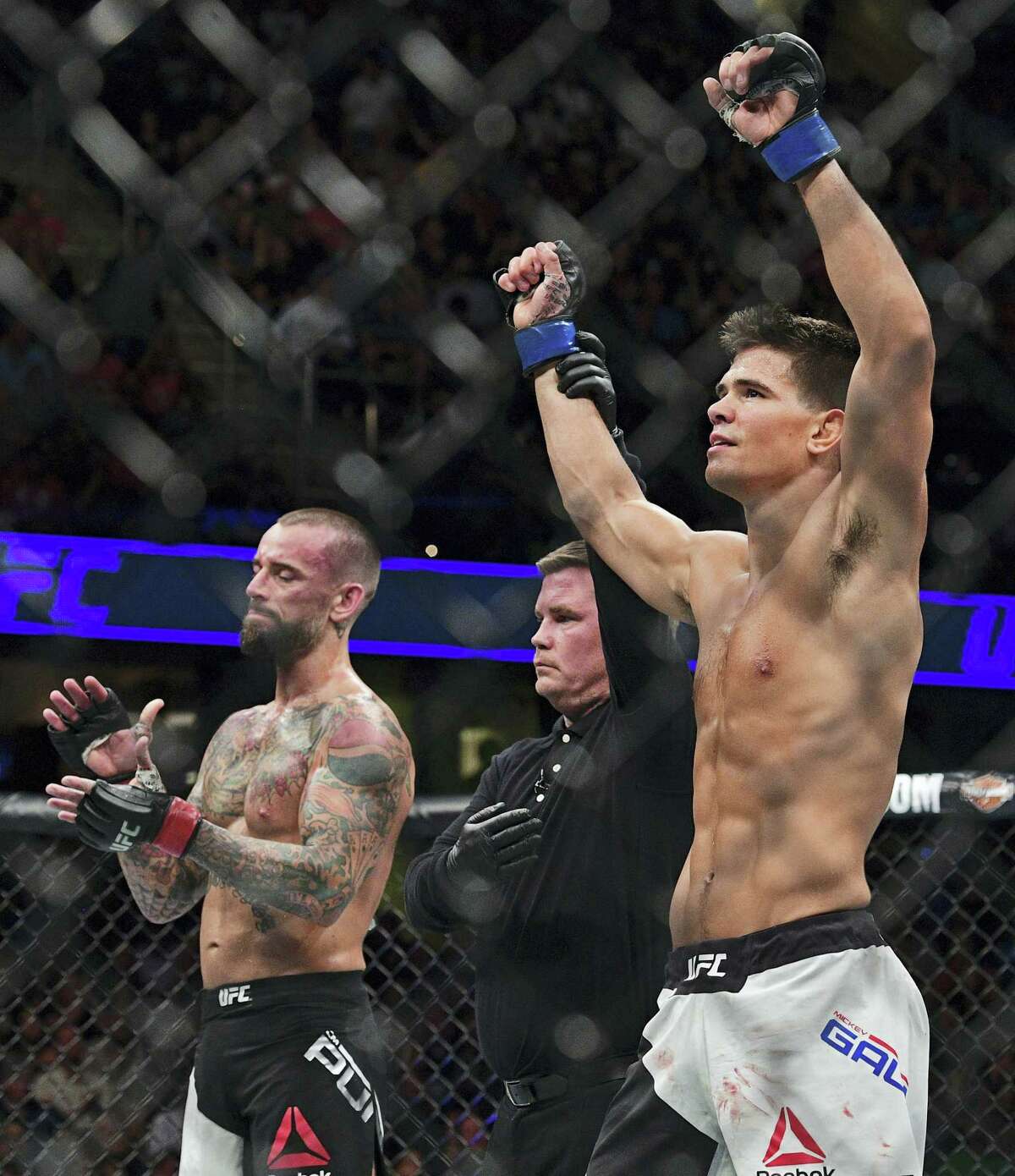 Mickey Gall has his arm raised by the referee after defeating CM Punk during a welterweight bout at UFC 203 on Saturday in Cleveland.