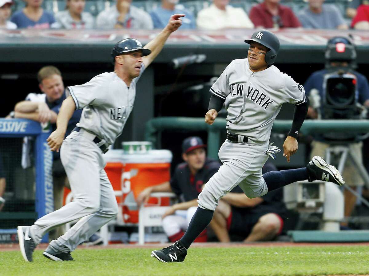 Ronald Torreyes (17) gets waved home by third base coach Joe Espada to score the go-ahead run against the Indians on Saturday.