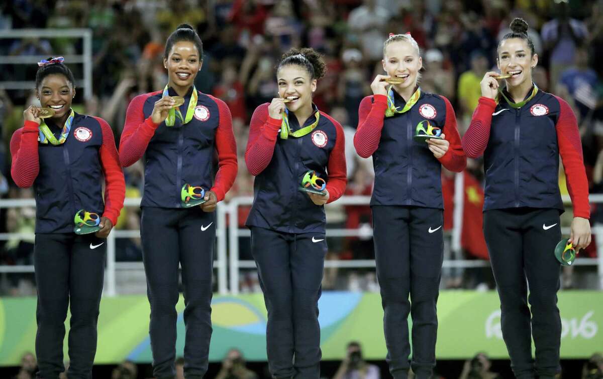 From left, U.S. gymnasts Simone Biles, Gabrielle Douglas, Lauren Hernandez, Madison Kocian and Aly Raisman hold their gold medals during the medal ceremony on Tuesday.