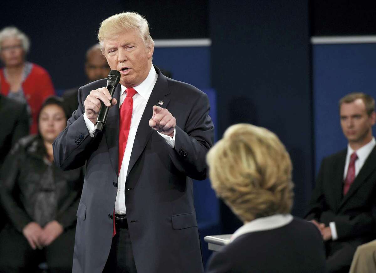 Republican presidential nominee Donald Trump points at Democratic presidential nominee Hillary Clinton as he speaks during the second presidential debate at Washington University in St. Louis Sunday.