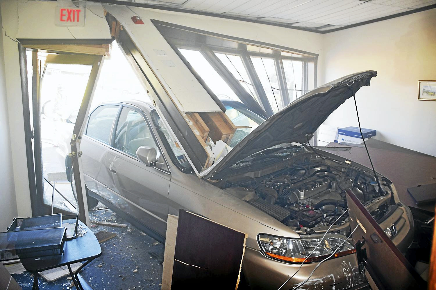 1 hurt after car crashes into building in Milford