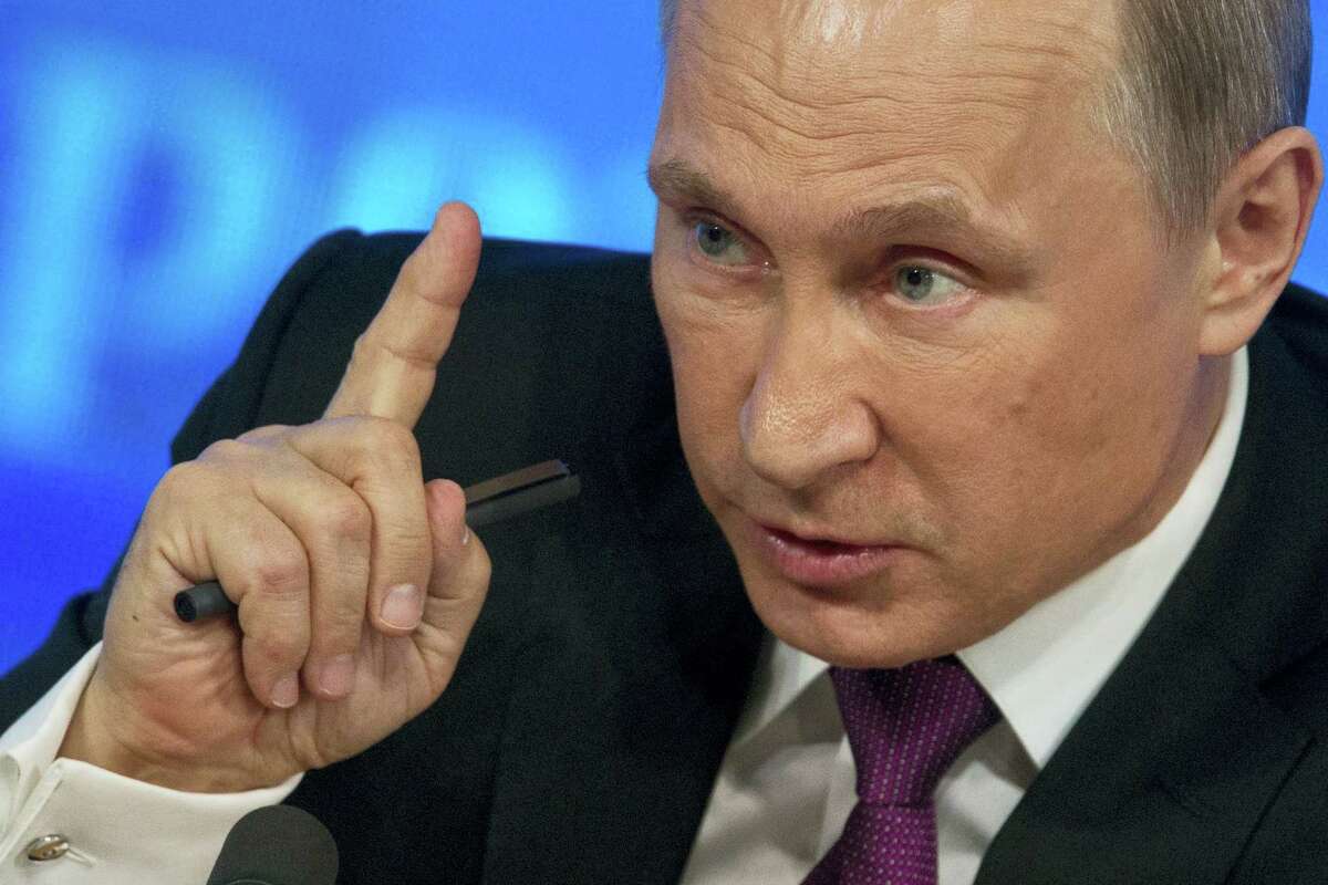 Russian President Vladimir Putin gestures during his annual news conference in Moscow, Russia, Thursday, Dec. 18, 2014. The Russian economy will rebound and the ruble will stabilize, Russian President Vladimir Putin said Thursday at his annual press conference, he also said Ukraine must remain one political entity, voicing hope that the crisis could be solved through peace talks.