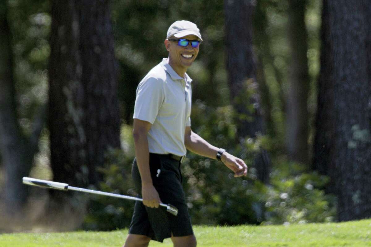 President Barack Obama smiles after putting on the first green during a round of golf at Farm Neck Golf Course in Oak Bluffs, Mass., on Martha’s Vineyard on Sunday.
