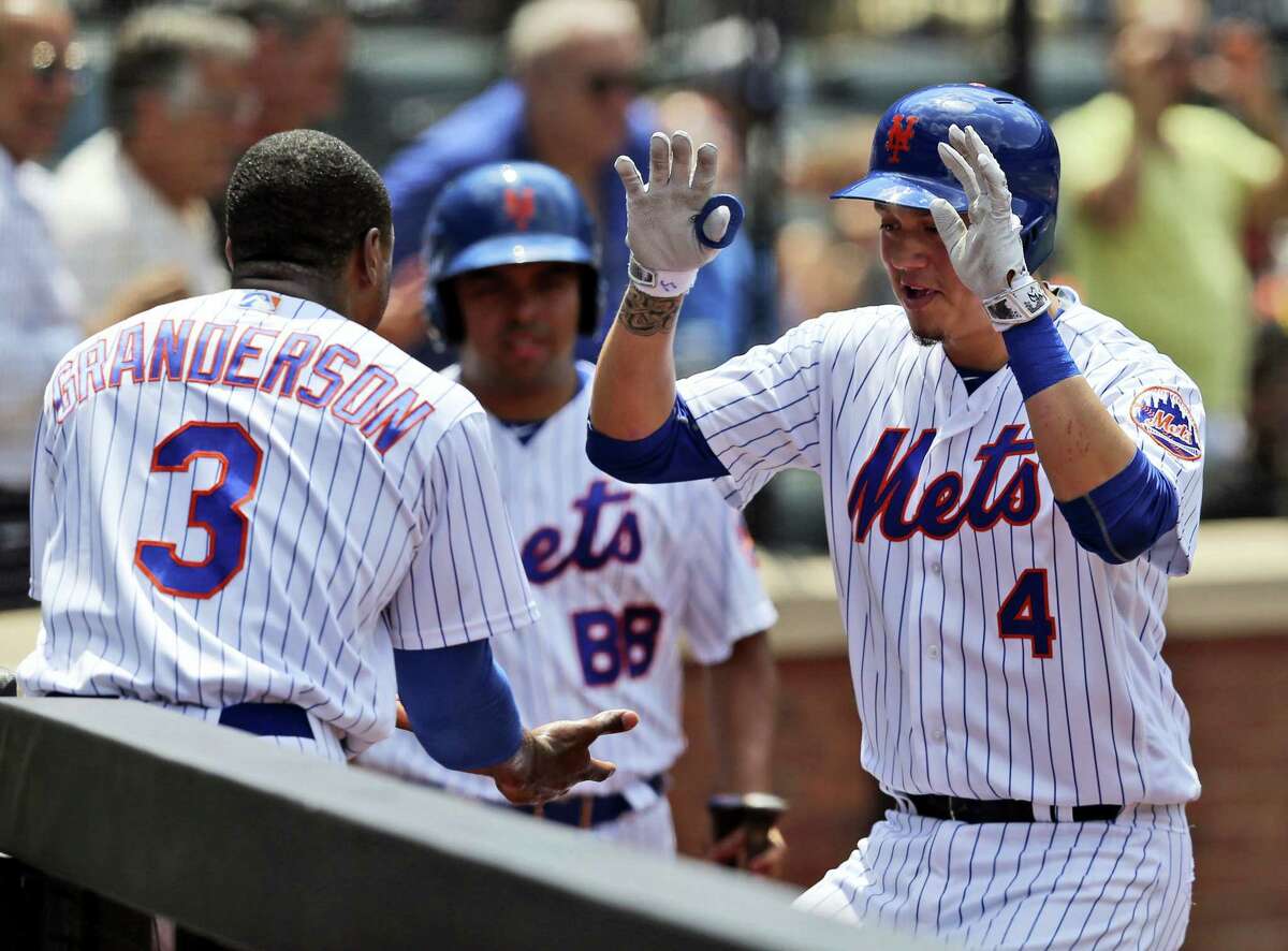 Wilmer Flores, right, celebrates his homer with Curtis Granderson during the fourth inning at Citi Field Wednesday. The nEW yORK Mets defeated the mIAMI Marlins 4-2.