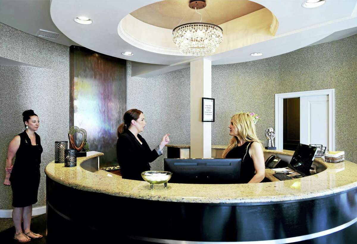 (Peter Hvizdak - New Haven Register)Distinctions Spa of Guilford employees Nicholl "Nikki" Sharpe, a hairstylist, left, Tara Gagliardi, an estician and skin care specialist, center, and owner Jennifer Alers in the reception area of the spaTuesday, May 27, 2016