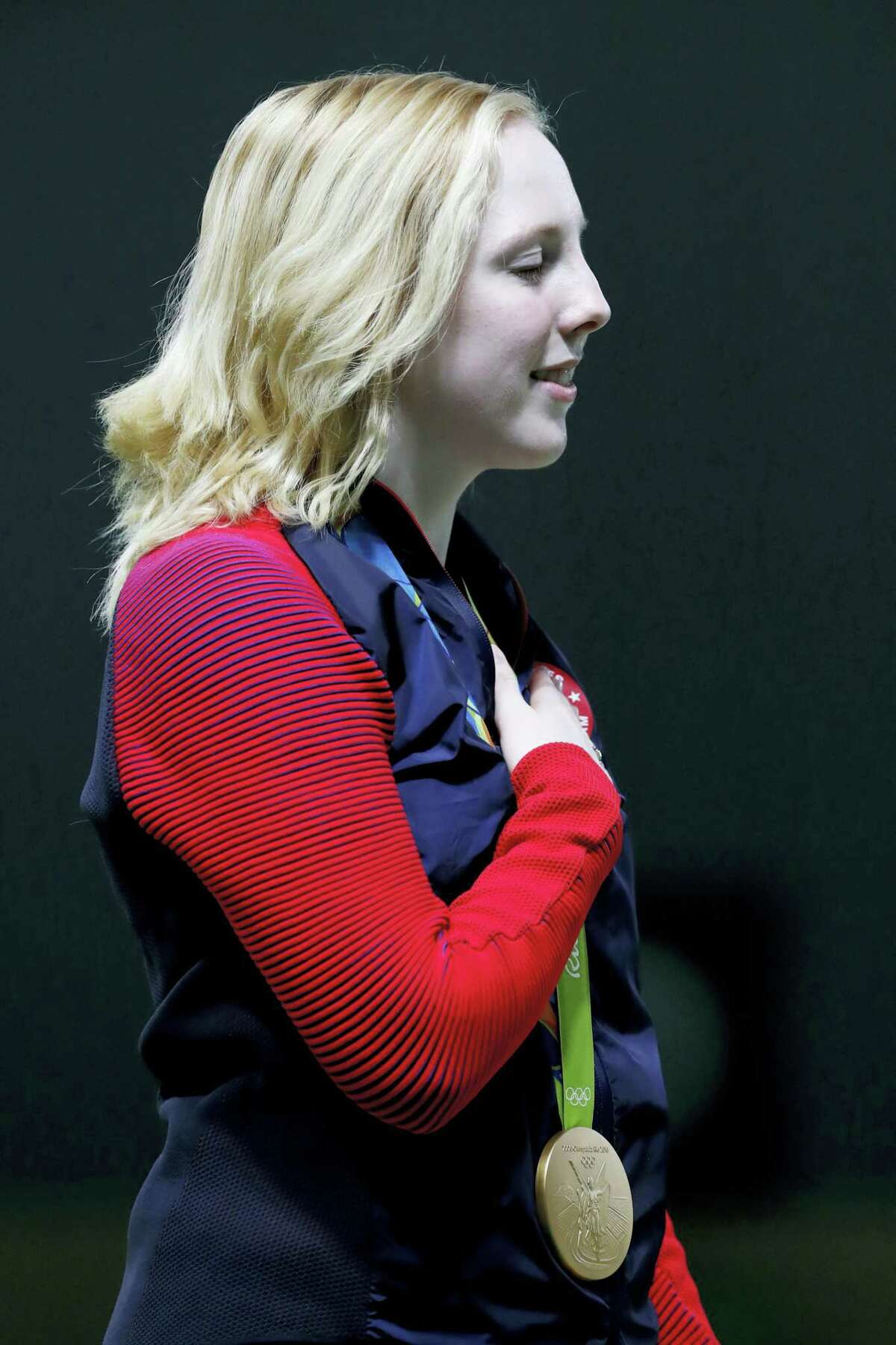 Gold medal winner, Virginia Thrasher of the United States, sings along with the U.S. national anthem after receiving the gold medal during the victory ceremony for the Women’s 10m Air Rifle event at Olympic Shooting Center at the 2016 Summer Olympics in Rio de Janeiro on Saturday.