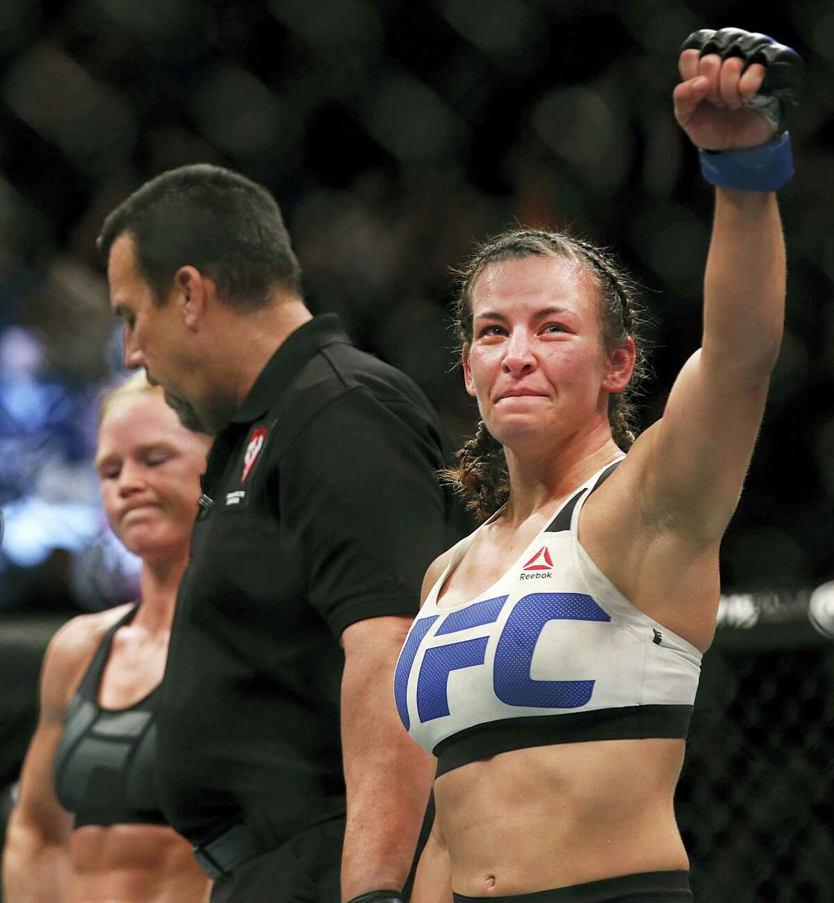 In this March 5, 2016 photo, Miesha Tate, right, celebrates her victory over Holly Holm in a UFC 196 women’s bantamweight mixed martial arts bout in Las Vegas.