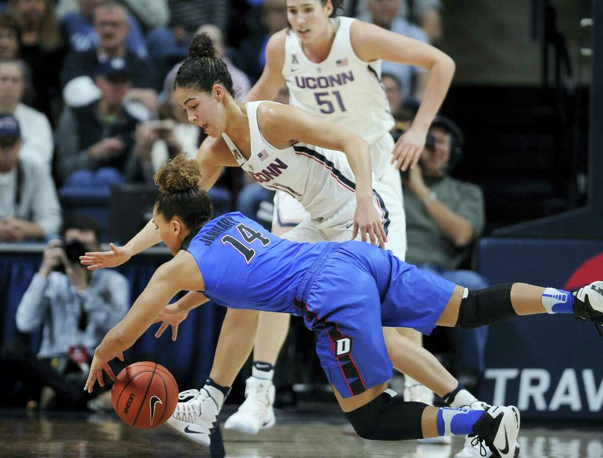 UConn’s Kia Nurse, top and DePaul’s Jessica January chase down a loose ball during the first half of the Huskies’ 91-46 win. Nurse scored a career-high 33 points.