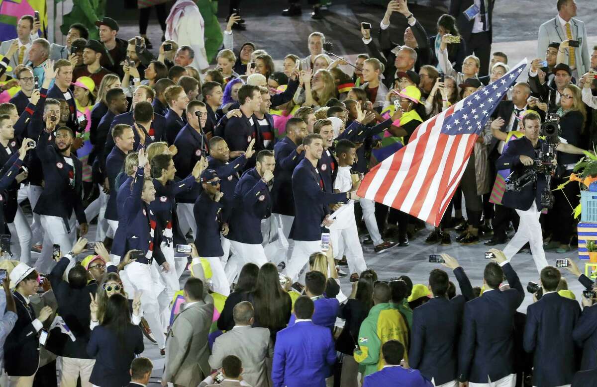 Michael Phelps carries the flag of the United States during the opening ceremony for the 2016 Summer Olympics in Rio de Janeiro, Brazil, on Friday.