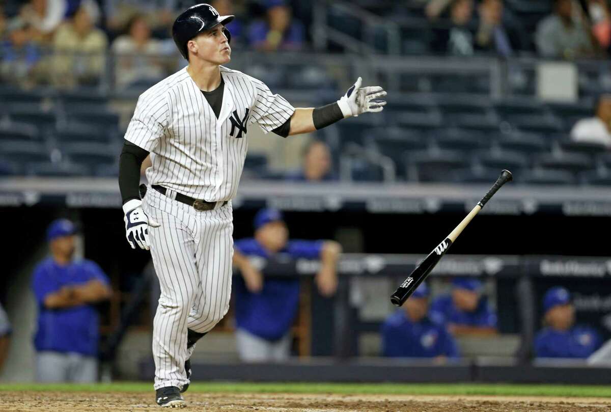 New York Yankees’ Tyler Austin drop his bat and watches his two-run home run in the seventh inning against the Toronto Blue Jays on Tuesday. The Yankees hung on to beat the Jays 7-6.