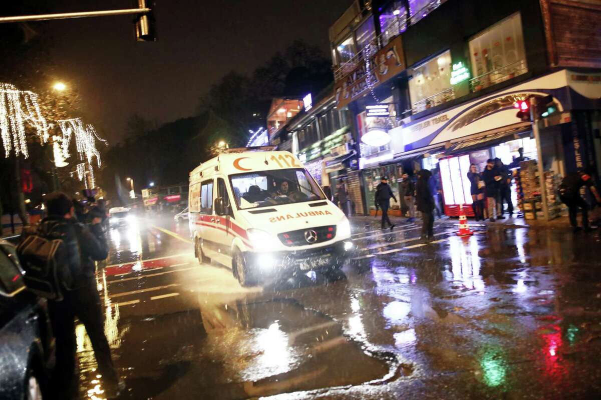 An ambulance rushes from the scene of an attack in Istanbul, early Sunday, Jan. 1, 2017. Turkey’s state-run news agency said an armed assailant has opened fire at a nightclub in Istanbul during New Year’s celebrations.