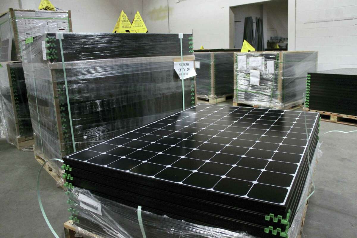 In this March 9, 2016 photo, the latest generation of SunPower solar panels are stacked in Positive Energy Solar’s warehouse in Albuquerque, N.M.