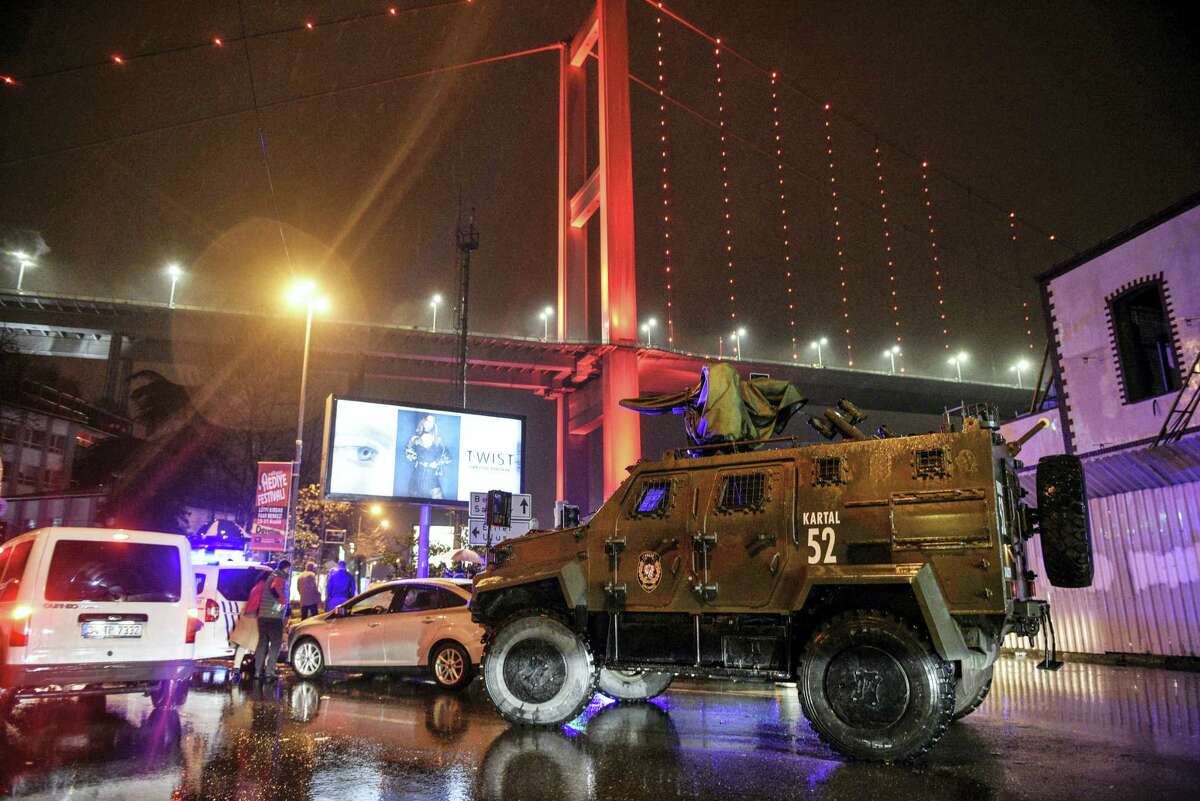 A police armored vehicle blocks the road leading to the scene of an attack in Istanbul, early Sunday, Jan. 1, 2017. Private NTV television said more than one assailant may have been involved in the attack. The attacker or attackers are believed to have entered the nightclub in Istanbul’s Ortakoy district disguised as Santa Claus, the station reported.