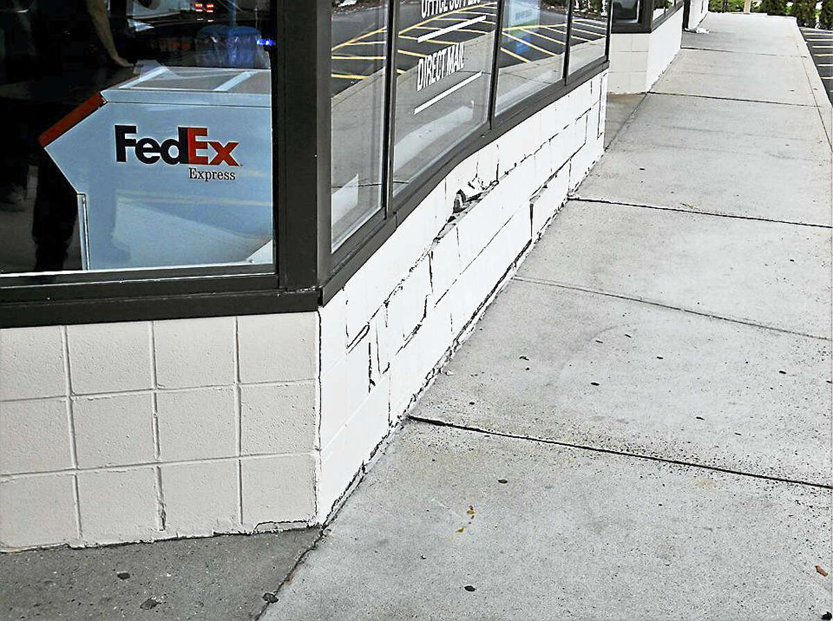 The damage after a car crashed into the FedEx office at 400 Boston Post Road in Orange.
