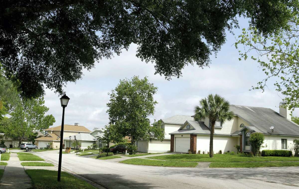 This April 14, 2016 photo shows a view of a street in the Piedmont Park neighborhood in Apopka, Fla. Many of the single-family homes in the neighborhood used to be owned by families, but now they’re owned by companies associated with big real estate investment firms. And the occupants are tenants, not owners.