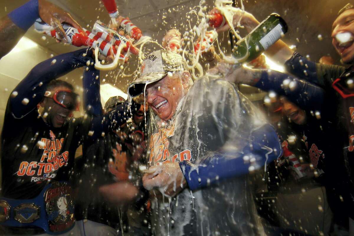 Mets manager Terry Colllins is doused with champagne and beer in the clubhouse after Saturday’s win over the Phillies.