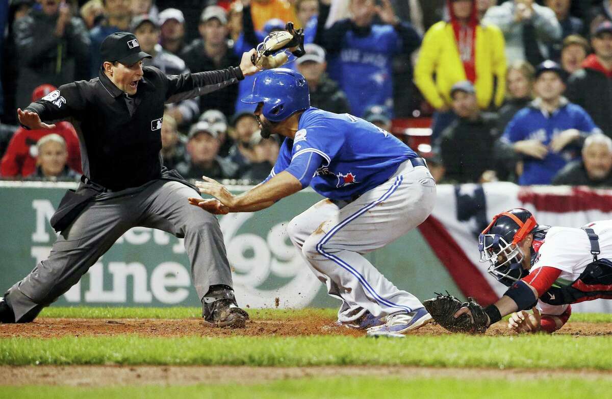 The Blue Jays’ Dalton Pompey, center, scores in front of Red Sox catcher Christian Vazquez in the ninth inning on Saturday.