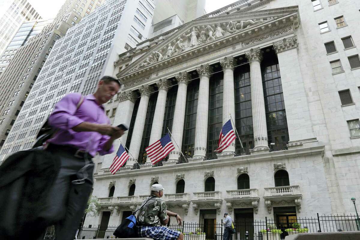 In this Friday, June 24, 2016, file photo, a man walks by the New York Stock Exchange. U.S. stock indexes were solidly higher in early trading Tuesday, June 28, 2016, as investors welcomed encouraging data on the economy and housing. The rebound followed even bigger gains in Europe as global markets recovered from a two-day rout triggered by Britain’s vote to leave the European Union.