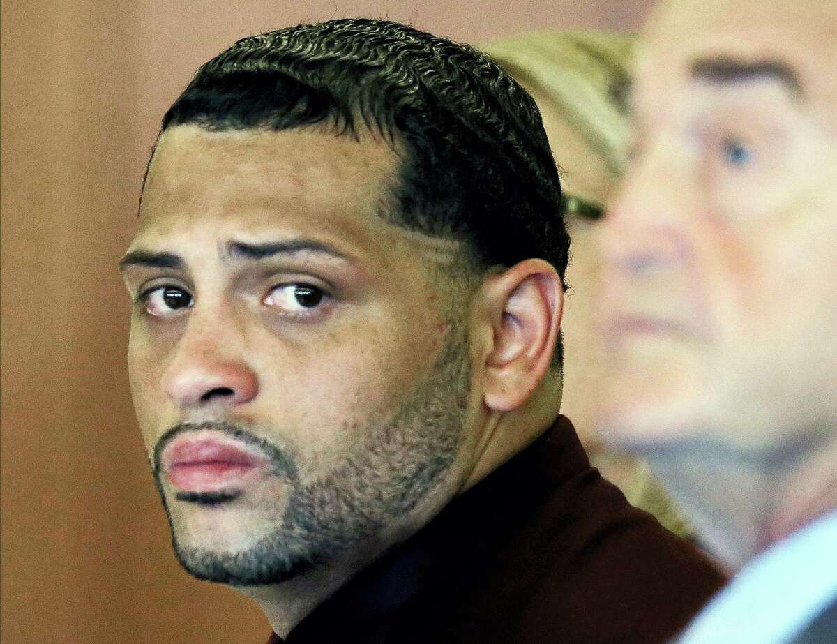 In this 2015 file photo, Carlos Ortiz, co-defendant of former New England Patriots player Aaron Hernandez, sits with his defense attorney John Connors.