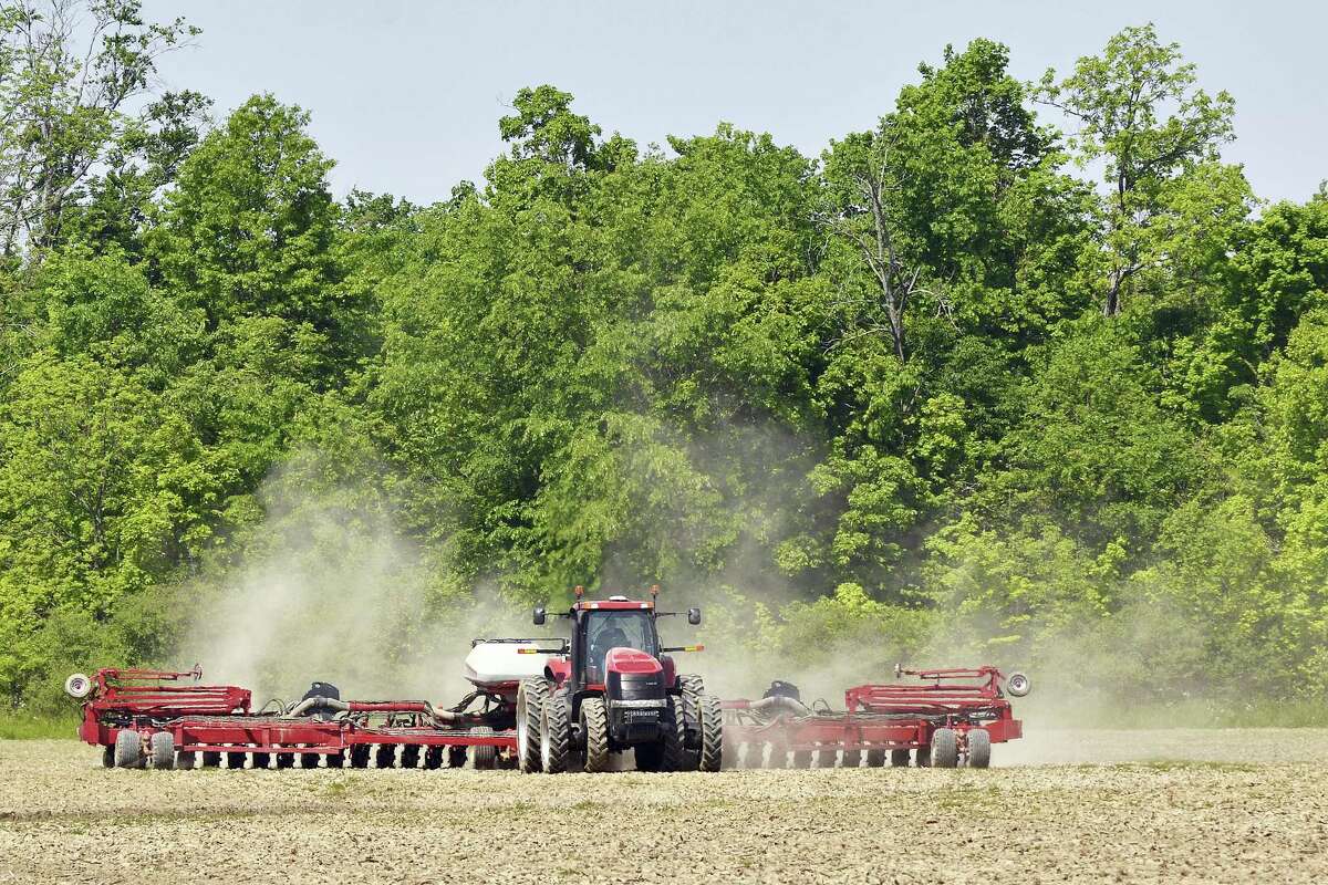 Dust rises as a Grant County farmer plants a field near Marion, Indiana.
