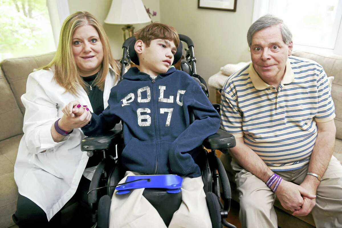 Left to right, Kim Hearn is photographed with her son, Sean, 11, and Robert Fiore, president and founder of Connecticut Epilepsy Advocate, Inc., at Hearn’s home in Stratford on 5/21/2016.