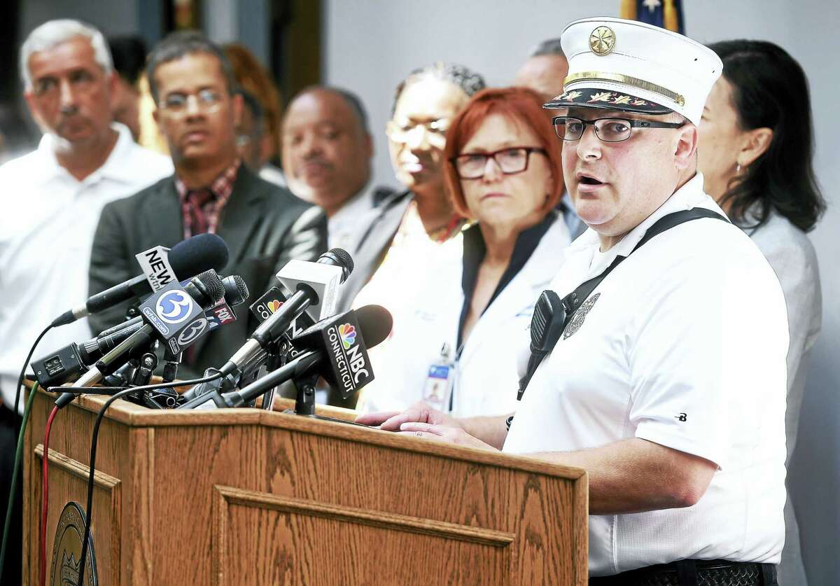 Assistant New Haven Fire Department Chief Matt Marcarelli, right, speaks at a press conference at the New Haven Police Department on Friday concerning the spike in synthetic drug overdoses in New Haven and surrounding towns and his department’s response.