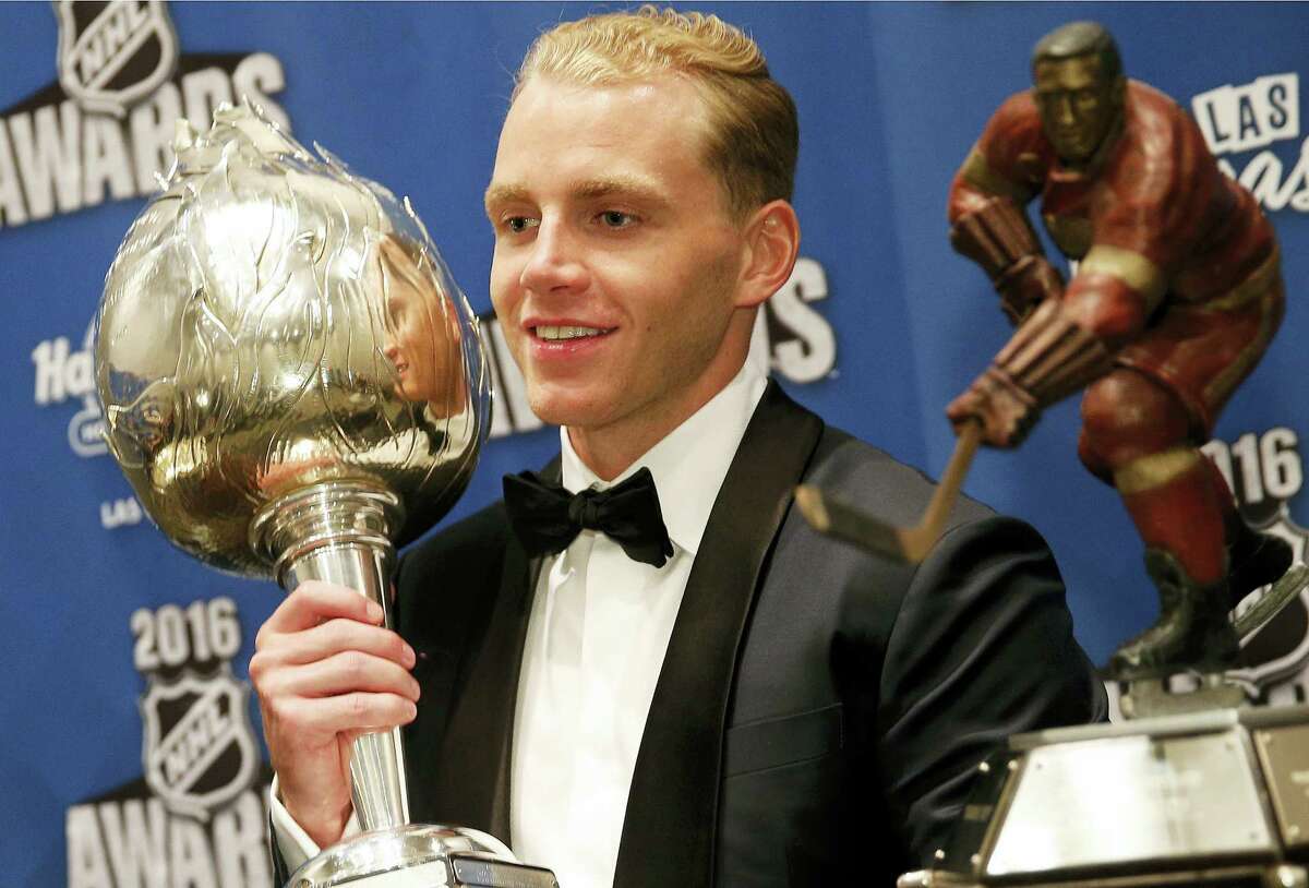 Chicago Blackhawks' Patrick Kane poses with the Hart Trophy, left, and the Ted Lindsay Award after winning the awards at the NHL Awards show, Wednesday, June 22, 2016, in Las Vegas. (AP Photo/John Locher)