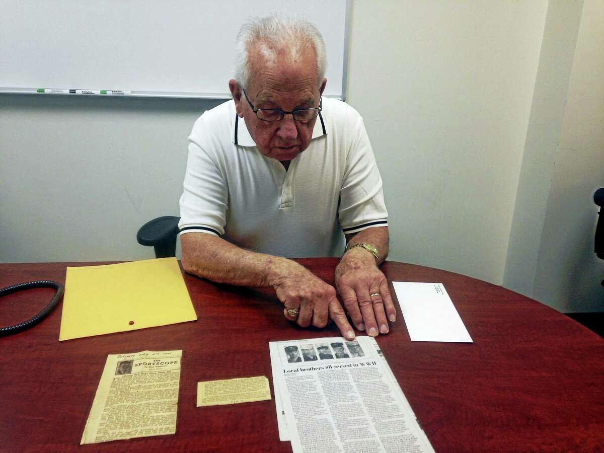 Robert C. Ruby looks over an article in the Journal Courier written based on a letter he submitted while he was in the Army during WWII.