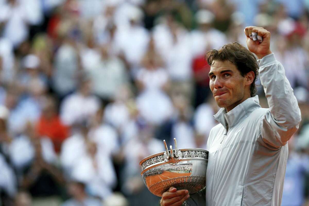This June 8, 2014, file photo shows Spain’s Rafael Nadal holding the trophy after winning the final of the French Open tennis tournament against Serbia’s Novak Djokovic at the Roland Garros stadium, in Paris, France. Nadal appears to be inching closer to finding his old “King of Clay” form.
