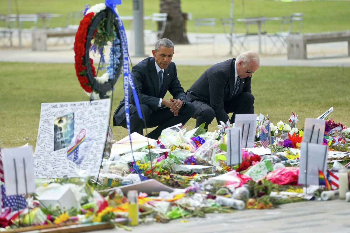 President Barack Obama and Vice President Joe Biden visit a memorial to the victims of the Pulse nightclub shooting, Thursday, June 16, 2016 in Orlando, Fla. Offering sympathy but no easy answers, Obama came to Orlando to try to console those mourning the deadliest shooting in modern U.S history.