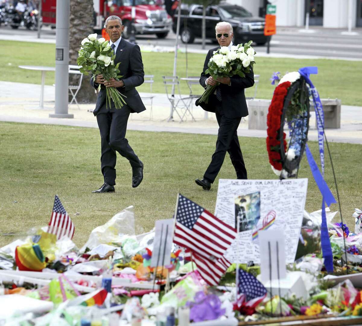 President Barack Obama and Vice President Joe Biden visit a makeshift memorial to the victims of the Pulse nightclub shooting, Thursday, June 16, 2016, in Orlando, Fla.