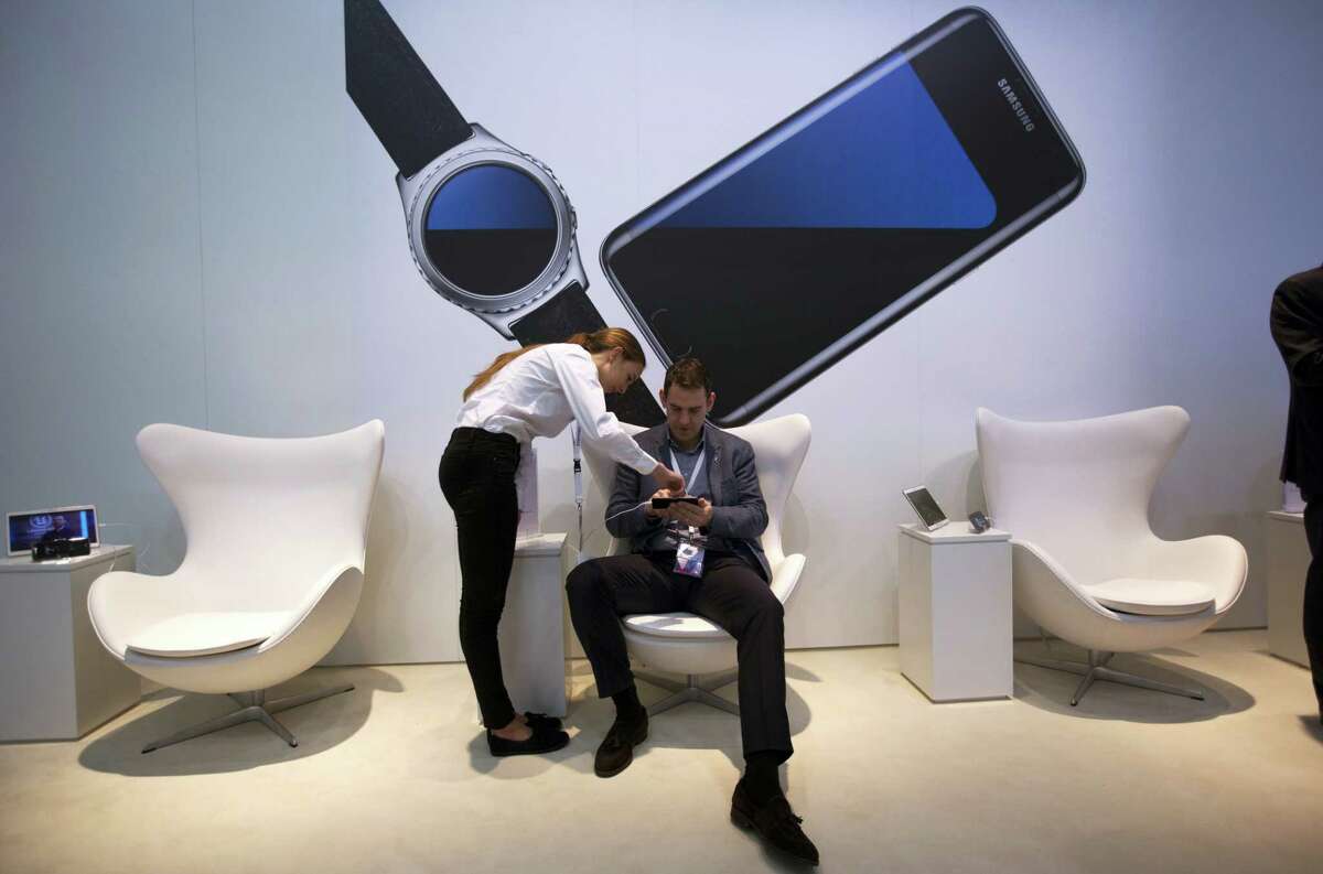 A man checks the new Galaxy S7 at the Mobile World Congress wireless show, in Barcelona, Spain.