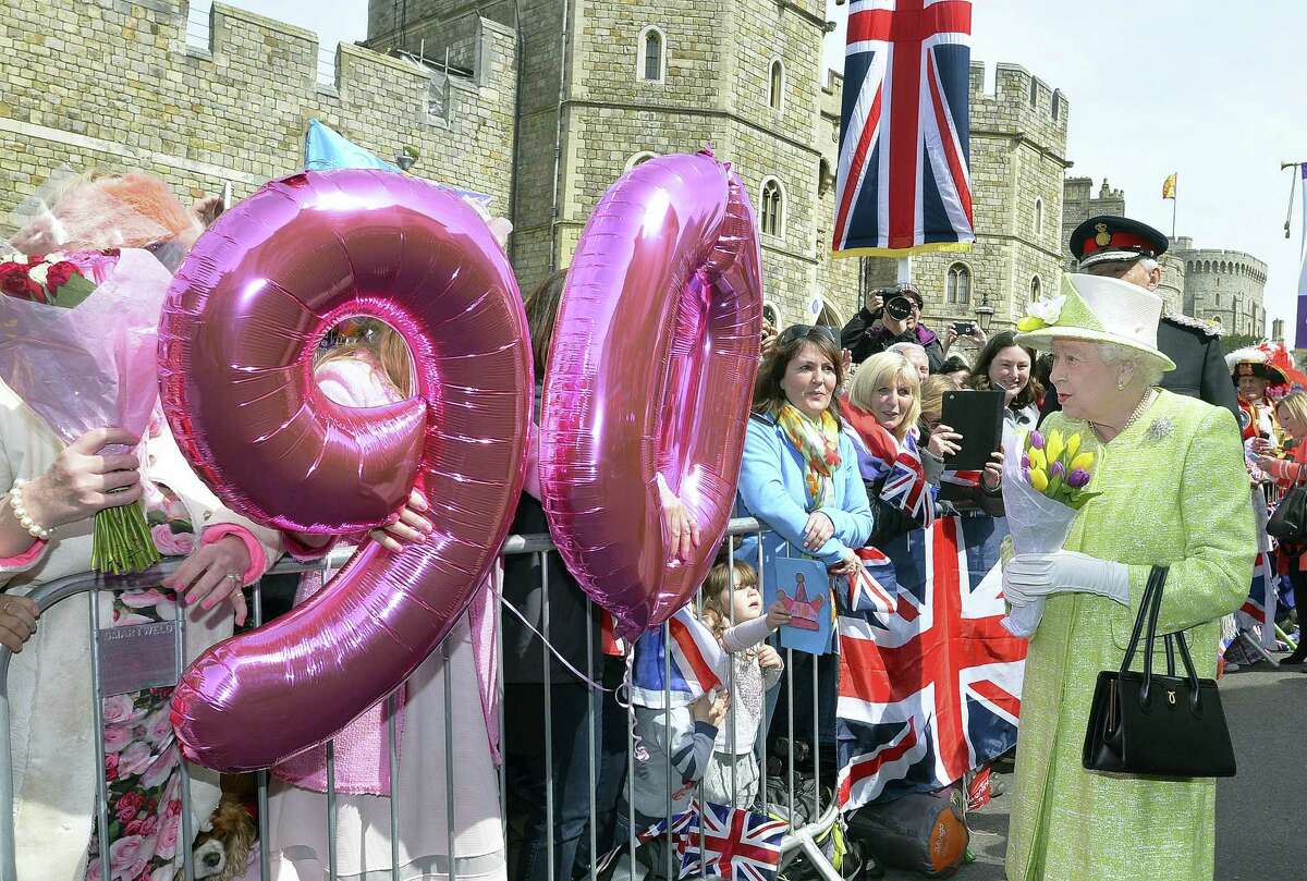 John Stillwell/PA via AP Britain’s Queen Elizabeth II meets well-wishers during a walkabout close to Windsor Castle in Berkshire as she celebrates her 90th birthday Thursday April 21, 2016.