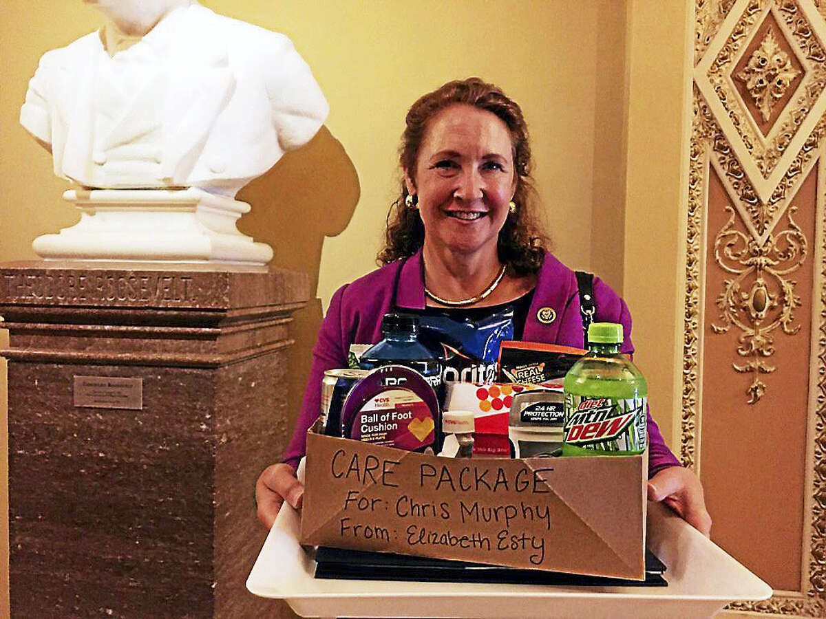 U.S. Rep. Elizabeth Esty, D-5, smiles as she carries what she tweeted was a care package for U.S. Sen. Chris Murphy on the Senate floor, where he launched a filibuster to force a vote on gun control legislation.