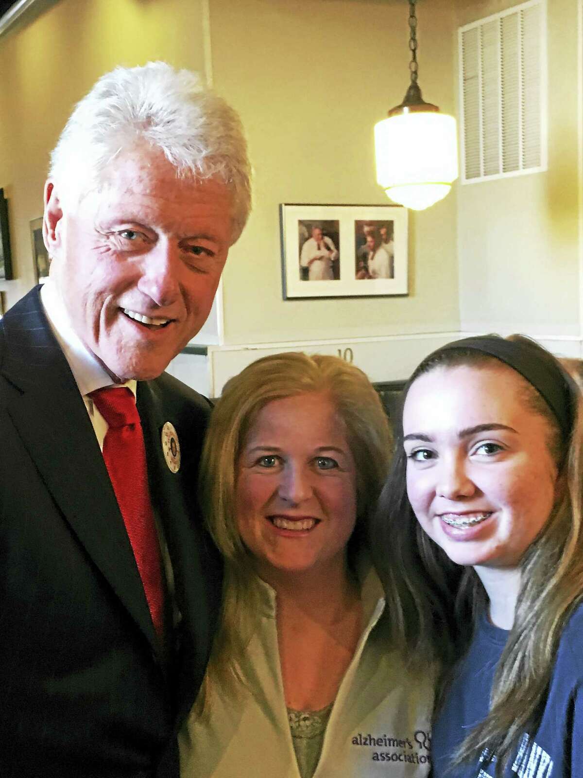 Former president Bill Clinton, left, with Nicole Brown and her niece Sydney Marsh at Pepe’s Thursday in New Haven.