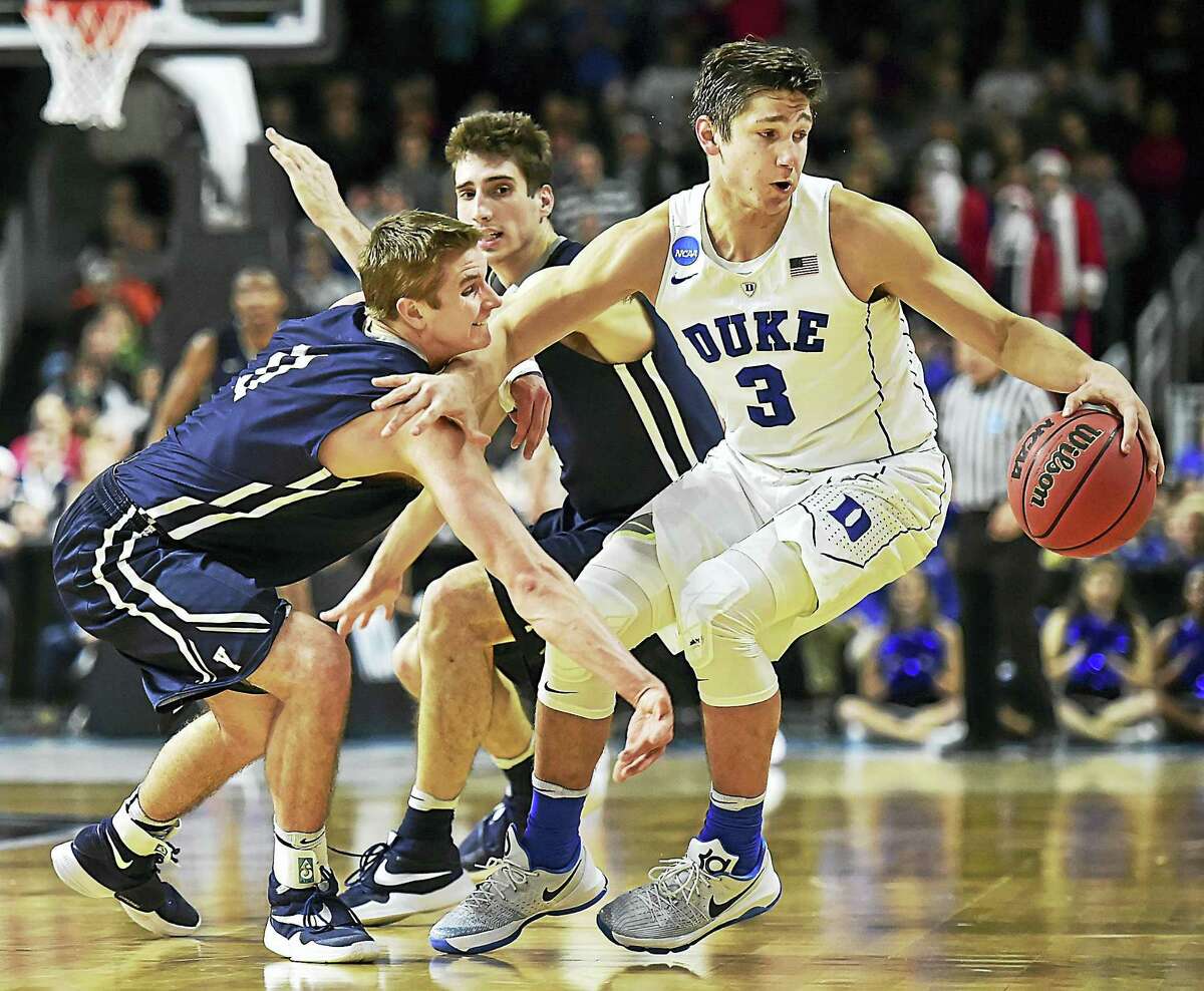 Yale guards Makai Mason (11) and Anthony Dallie (1) double team Duke guard Grayson Allen in a 71-64, loss for the Bulldogs, Saturday, March 19, 2016, in the second round of the 2016 NCAA Men's Basketball Tournament at the Dunkin' Donuts Center in Providence, RI. (Catherine Avalone/New Haven Register)